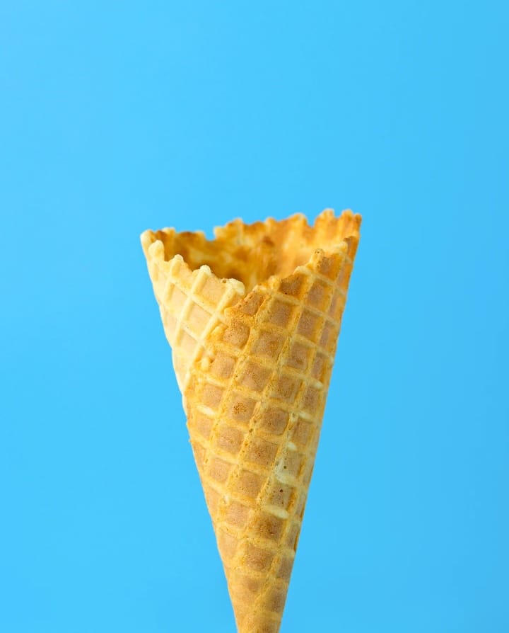 Empty ice cream cone on blue BG