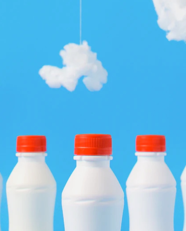 Milk bottles with clouds in BG