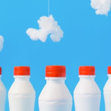 Milk bottles with clouds in BG