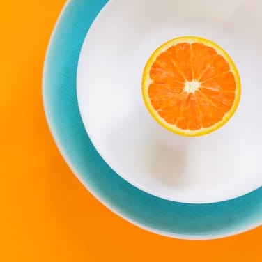 Half of orange on blue plate